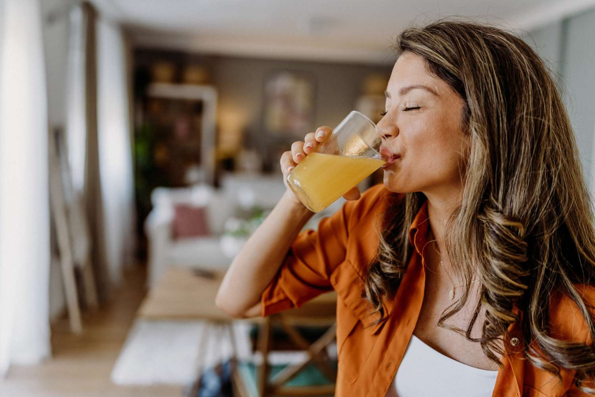 Femme buvant une boisson détox illustrant la tendance cortisol detox et le bien-être au quotidien